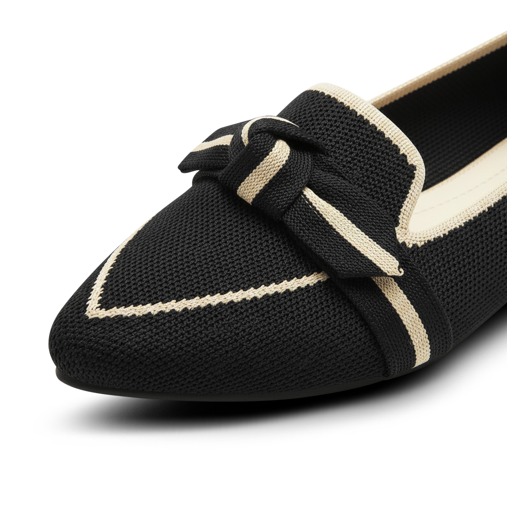 Black loafer with a bow detail on a white background
