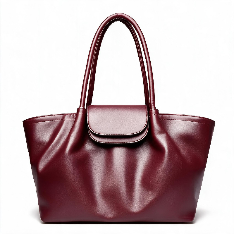 A large burgundy faux-leather tote bag with dual top handles and a flap closure, shown on a clean white background.