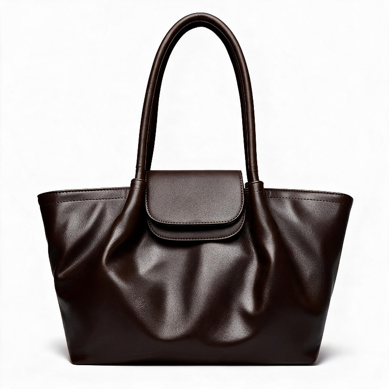 A dark brown faux-leather tote bag with a structured slouchy silhouette, dual top handles, and a matching flap closure, shown on a clean white background.